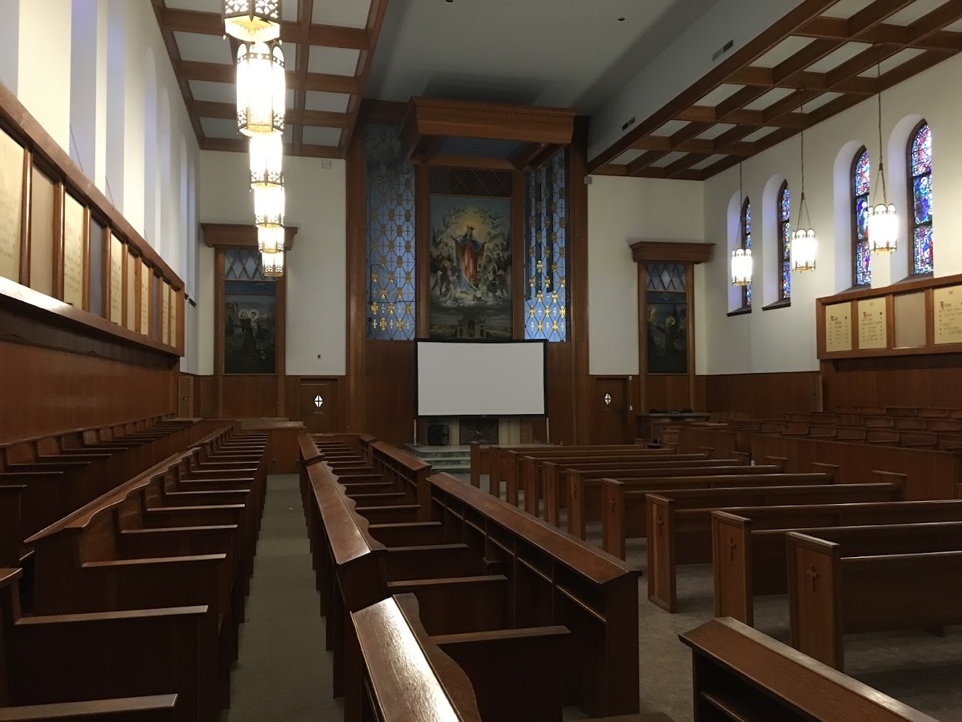 Church at the facility with stained-glass windows and whiteboard in front.