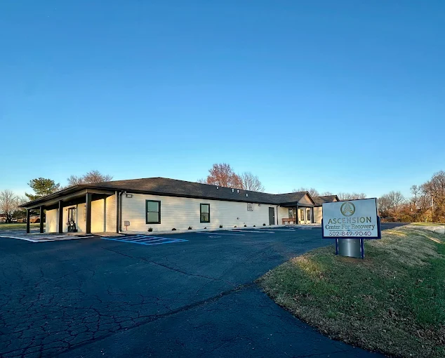 One-story rehab building with sign and parking area