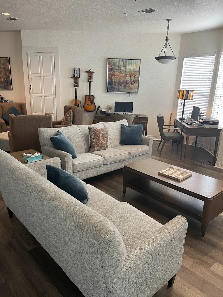 Living room with sofas coffee table and desk area