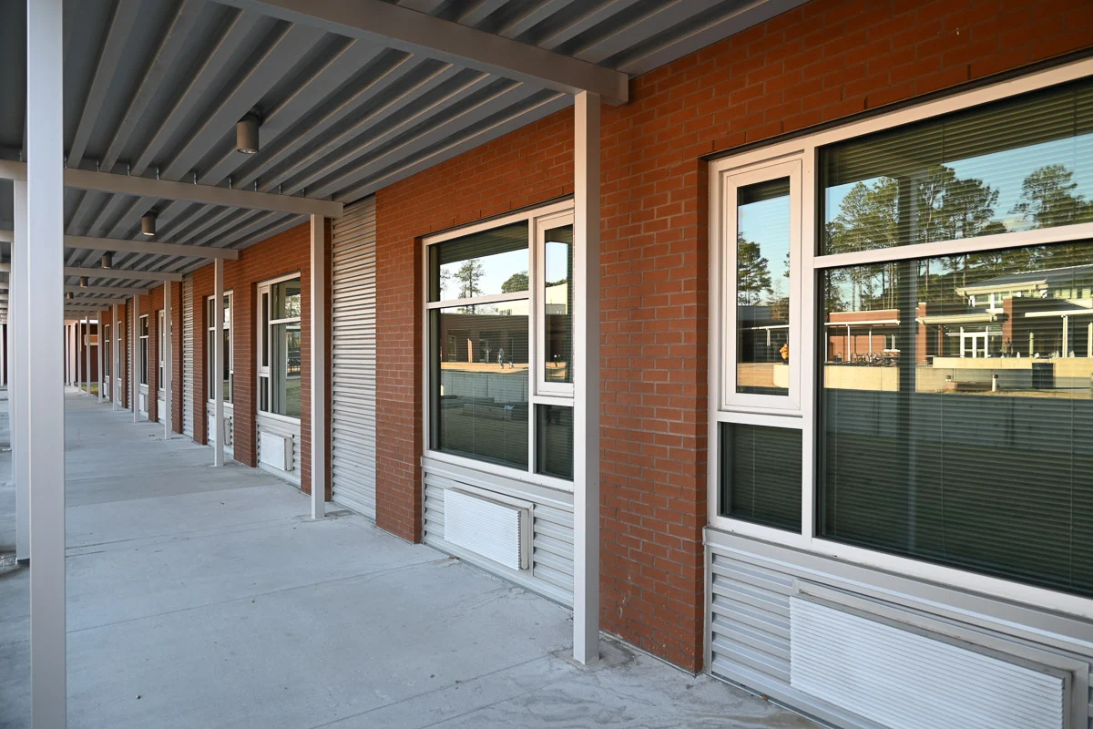 Brick building exterior with covered walkway and windows