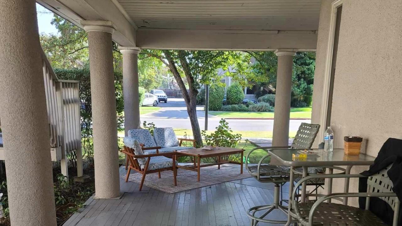 Shaded porch with patio seating and street view