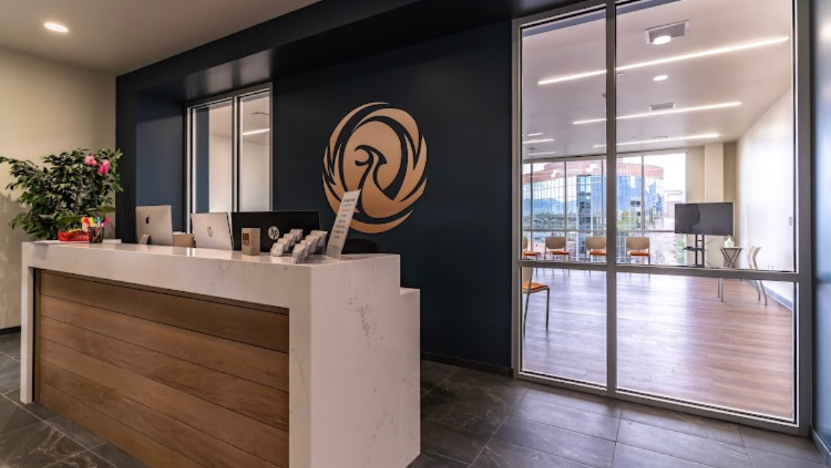 Modern reception desk with Phoenix logo and seating area