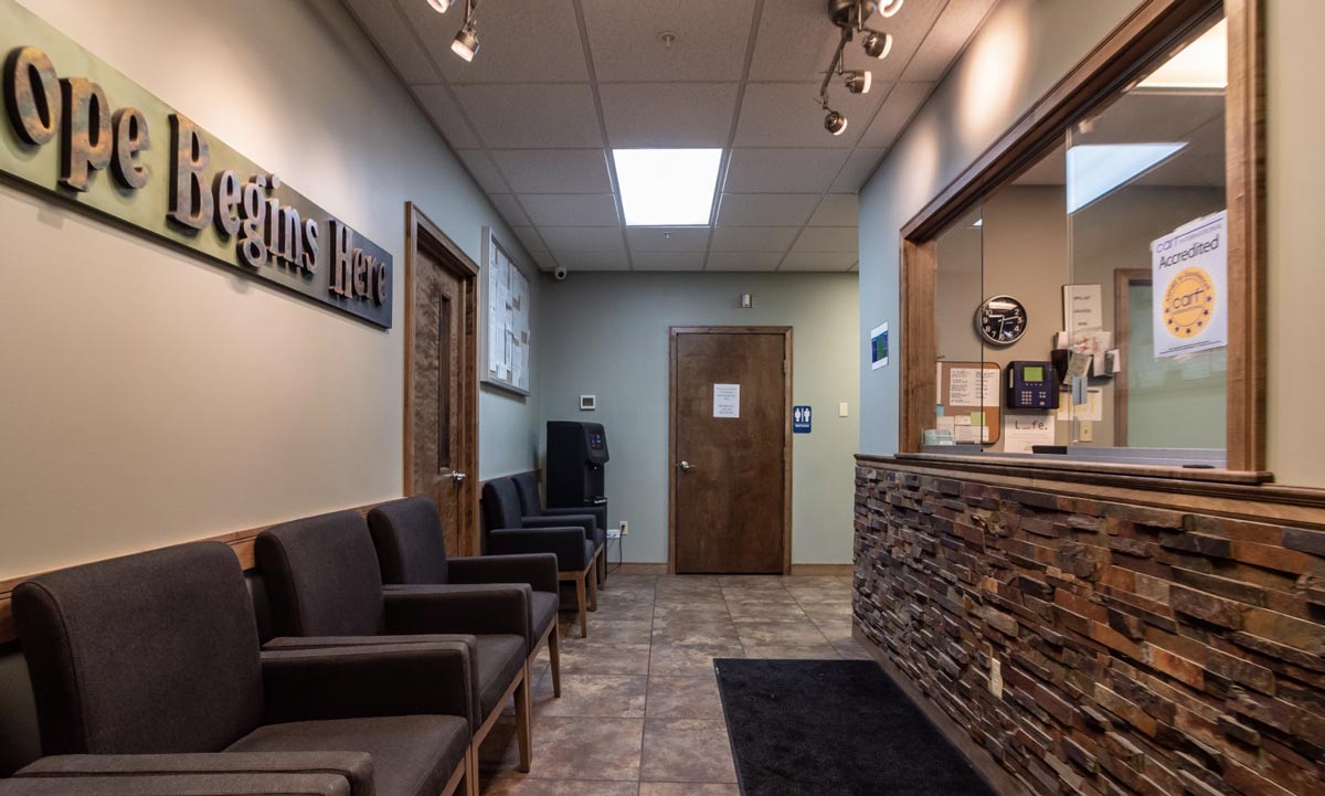 Reception area with chairs and a “Hope Begins Here” sign