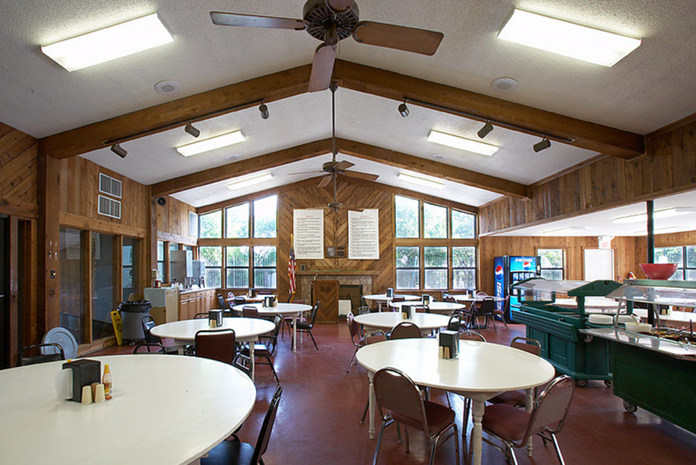 Large dining room with round tables and food station