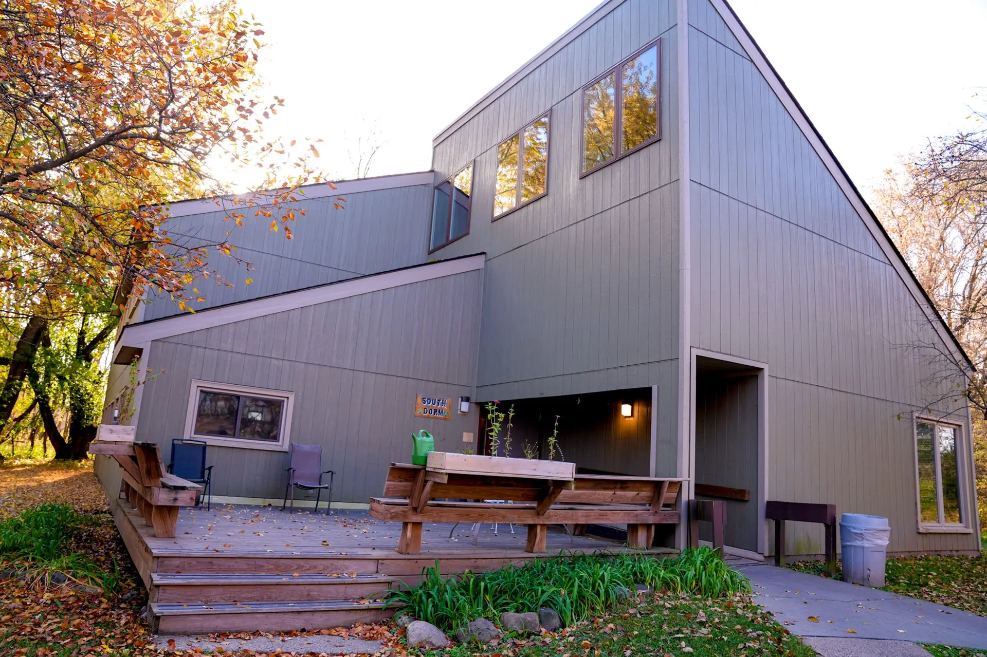 Modern rehab building with wooden deck and chairs outside