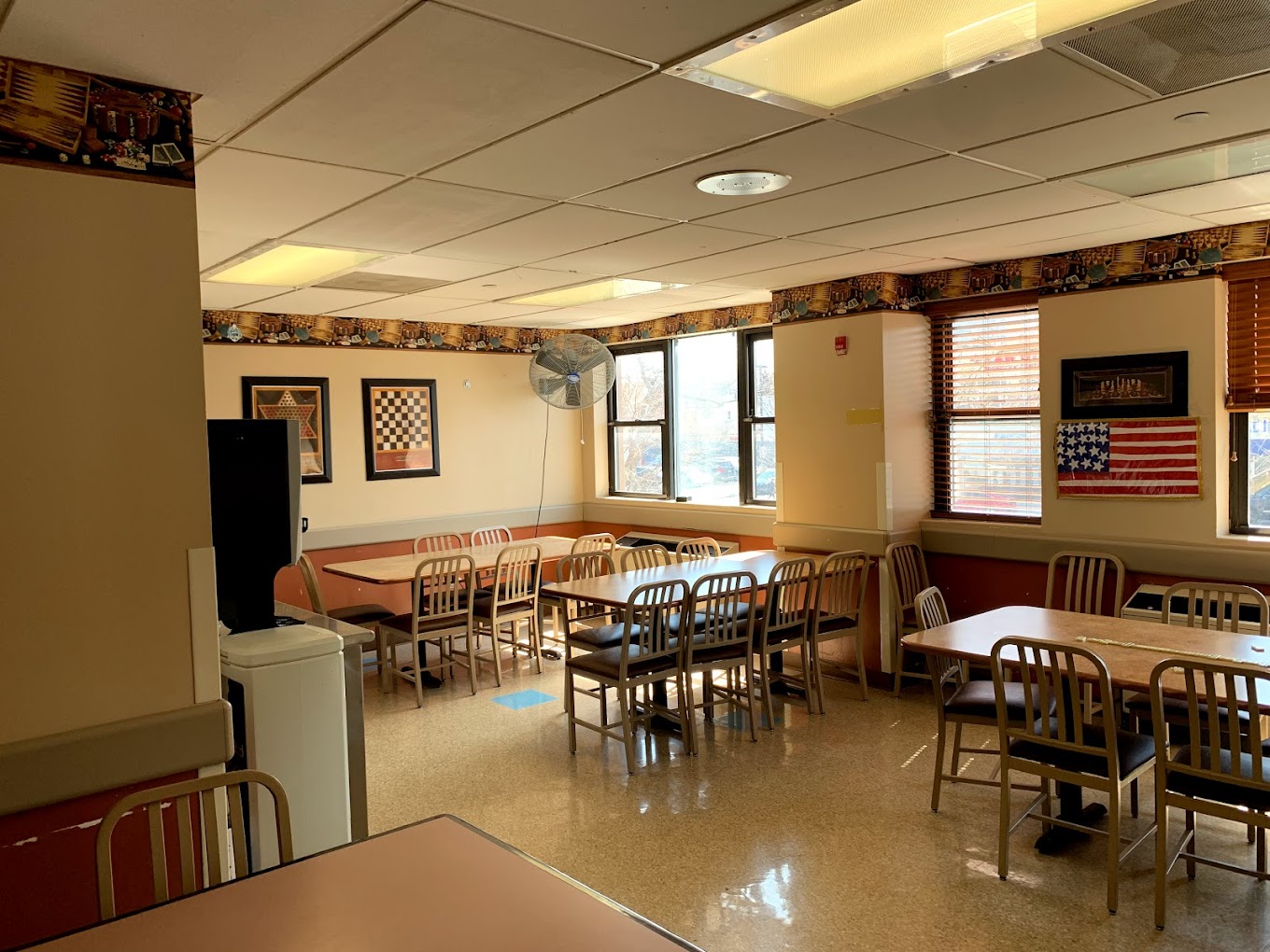 Dining room with tables and chairs for residents