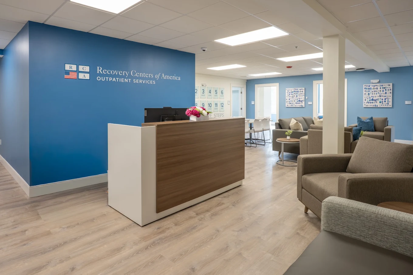 Reception desk and lounge seating in bright outpatient center