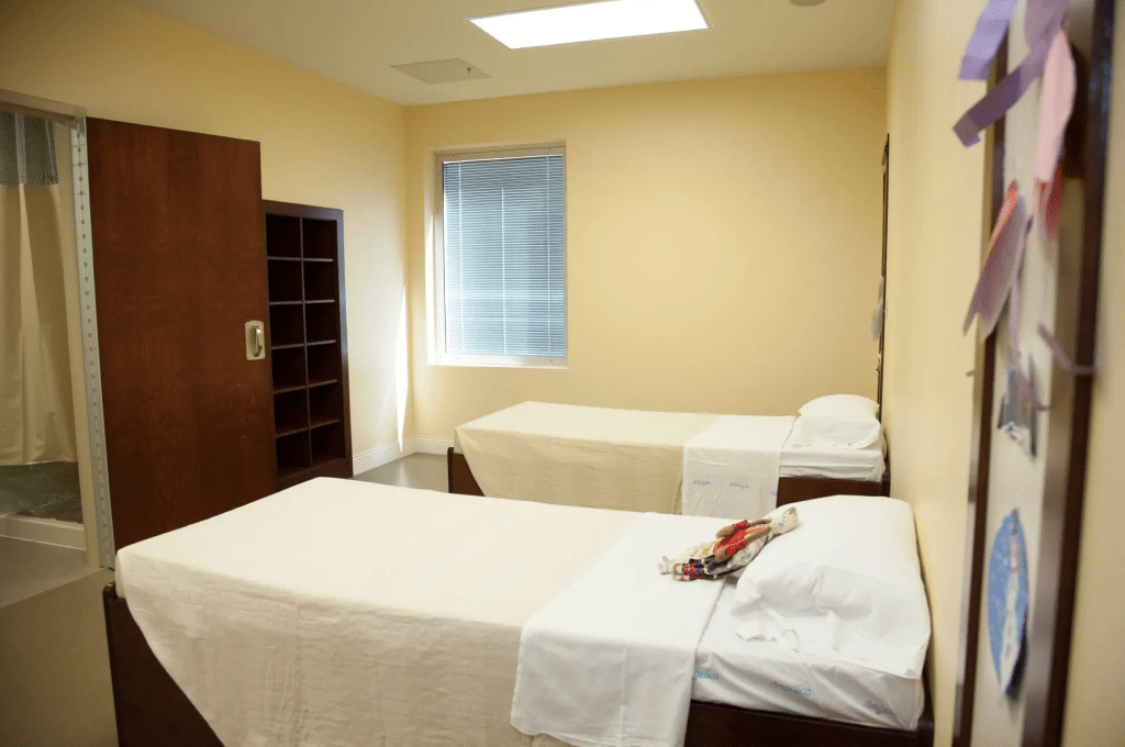 Two twin beds in a simply furnished patient bedroom