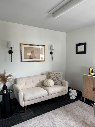 Cozy lounge with sofa, wall art, and soft lighting