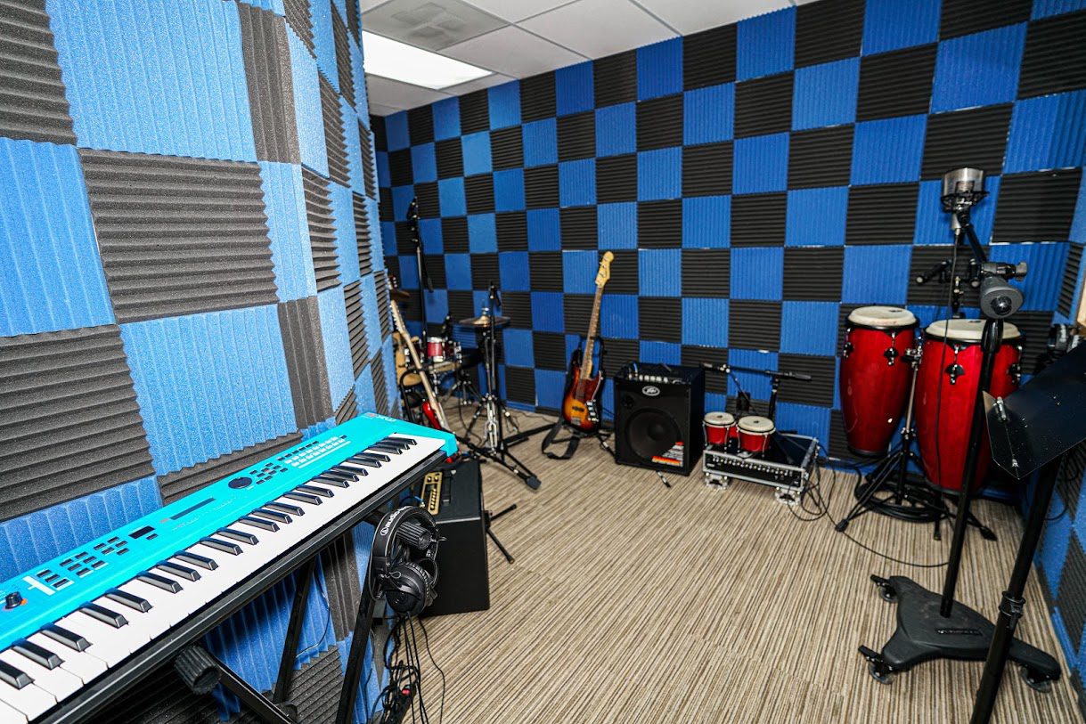 Soundproof music room with instruments and blue wall padding