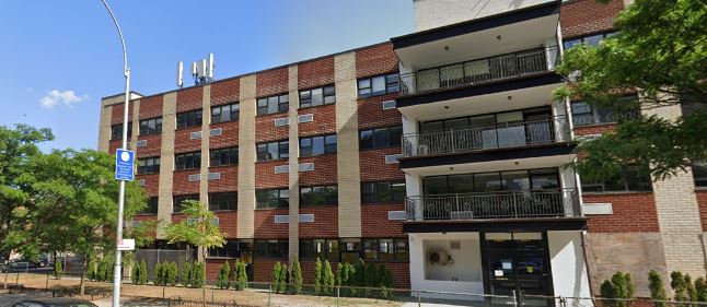 Brick rehab center building with balconies and sidewalk