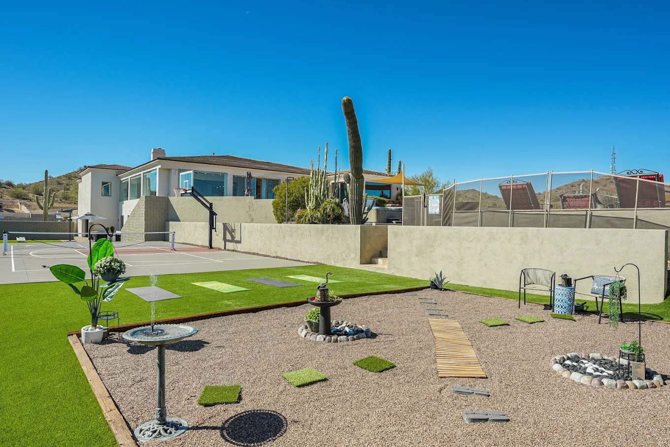 Outdoor space with putting green and sport court