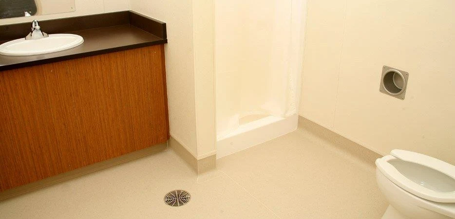 Restroom with sink, toilet, and shower stall