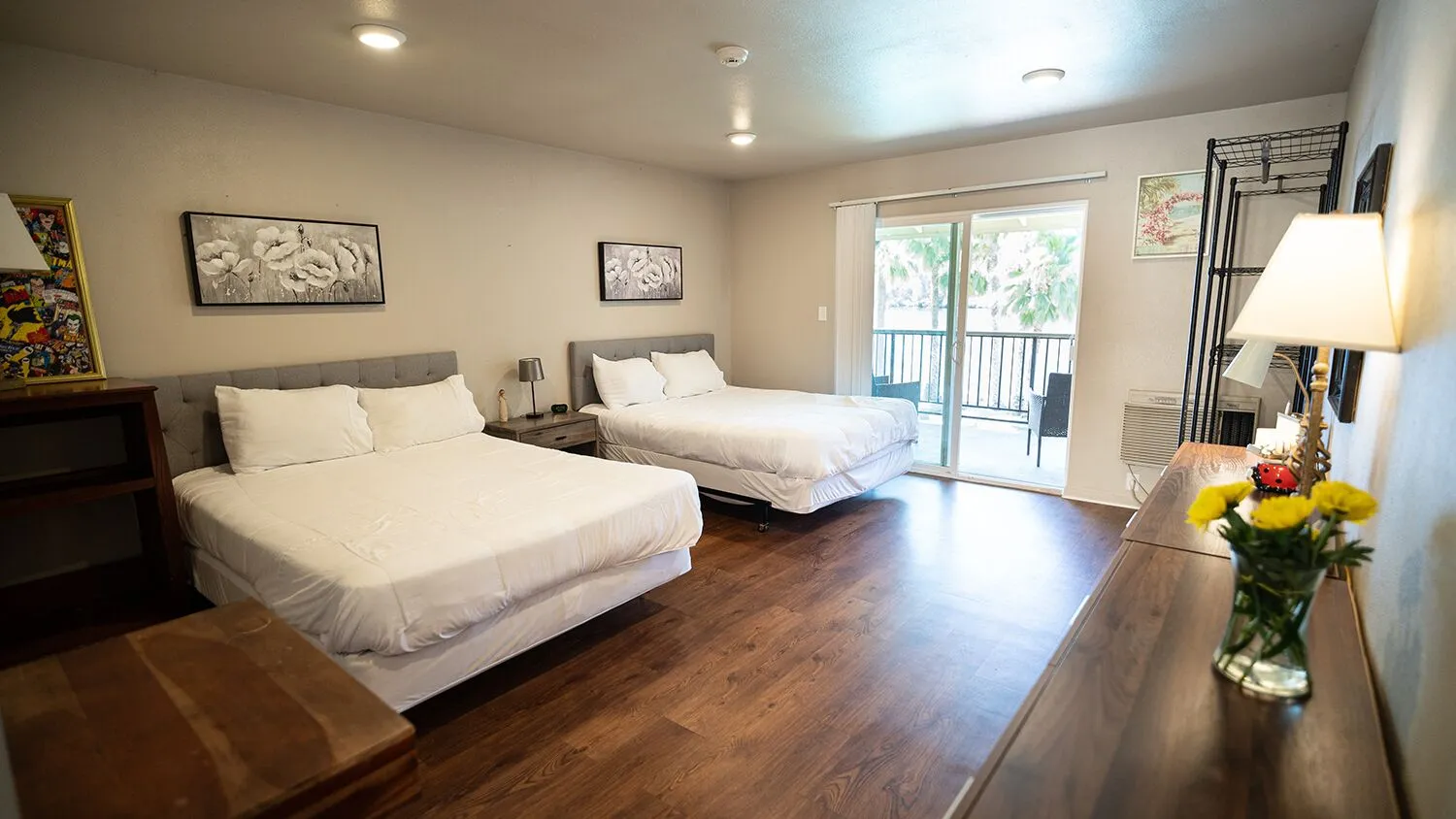 Spacious shared bedroom with two beds and balcony access.