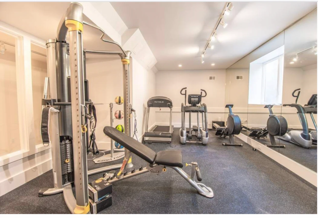 Gym with exercise machines and mirrored walls