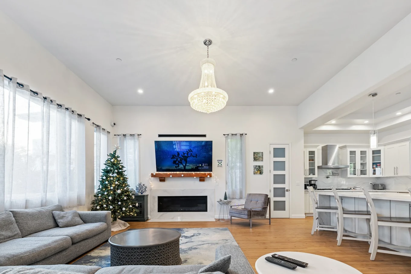 Lounge with sofas, large TV, and Christmas tree