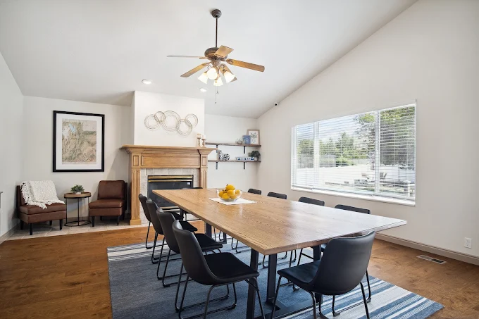 Dining space with fireplace and long table