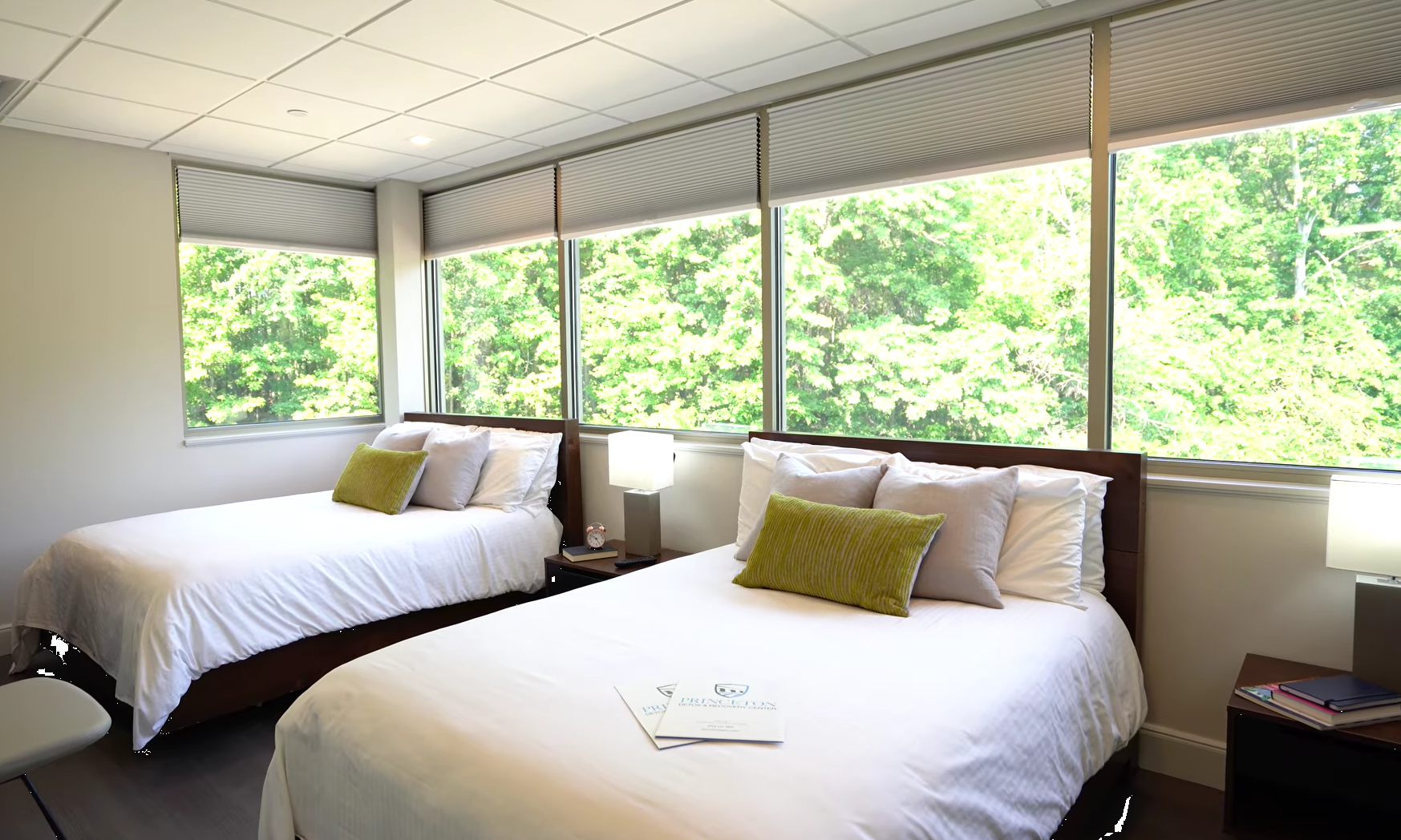 Shared bedroom with two beds and large windows