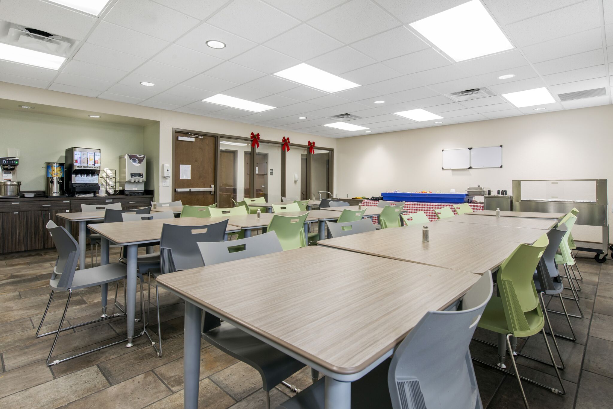 Rehab dining area with modern tables, chairs, and a food service counter.