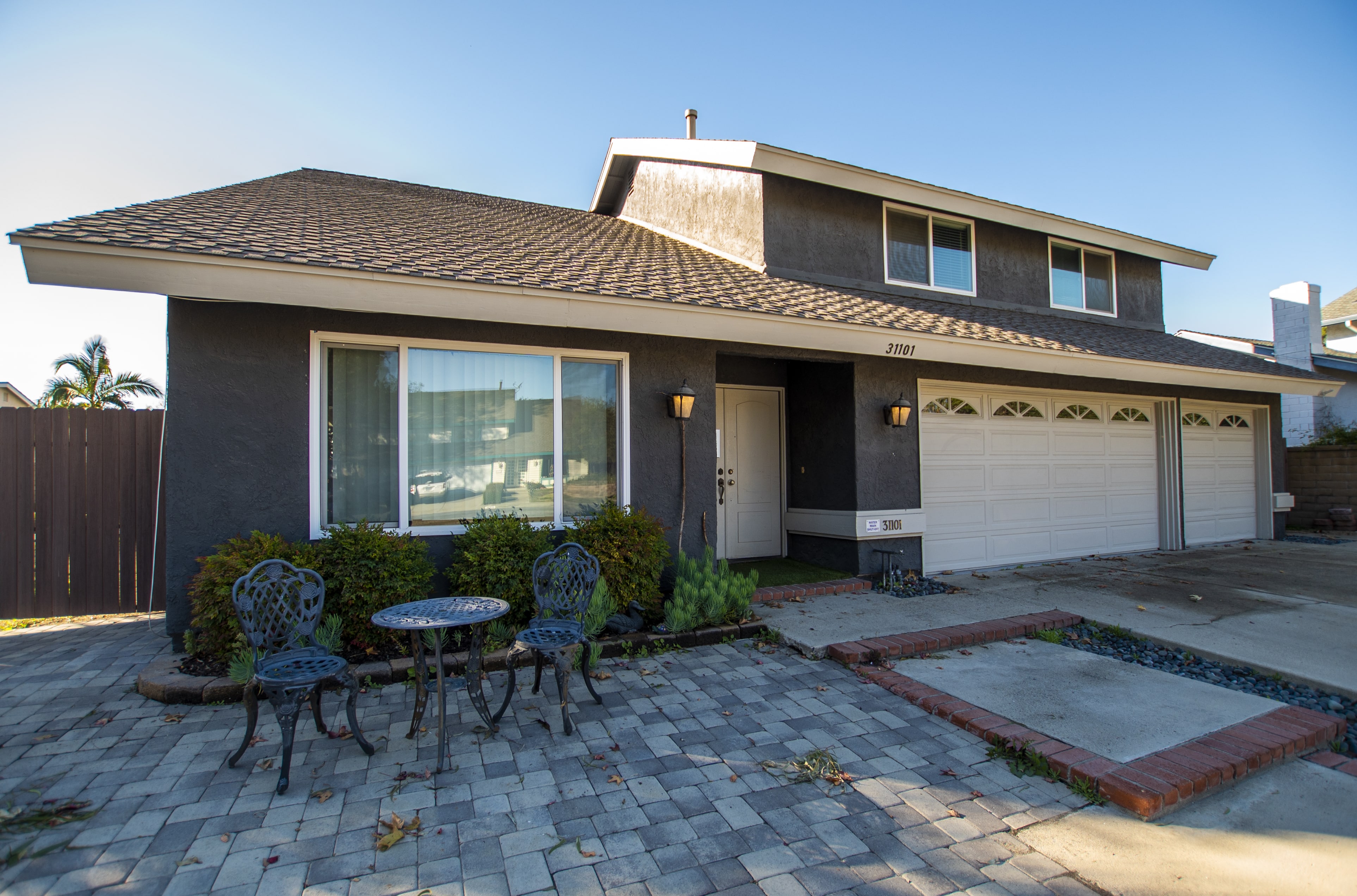 Two-story house with paved front patio