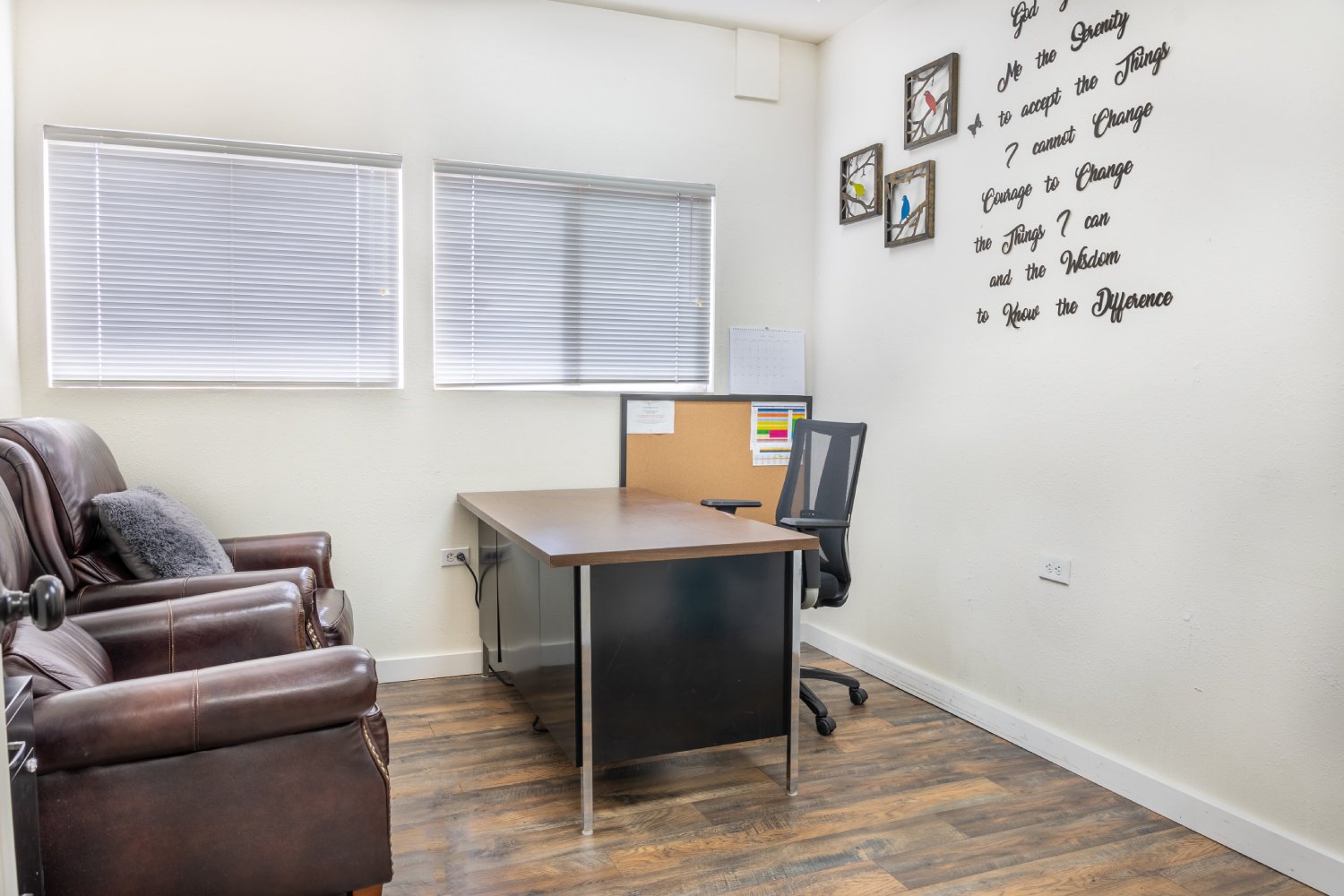 Small office with a desk, chair, and laptop