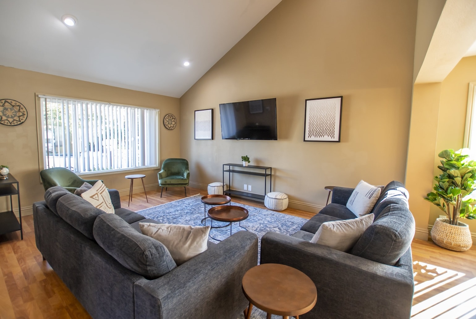 A modern lounge area with a large TV and stylish seating.