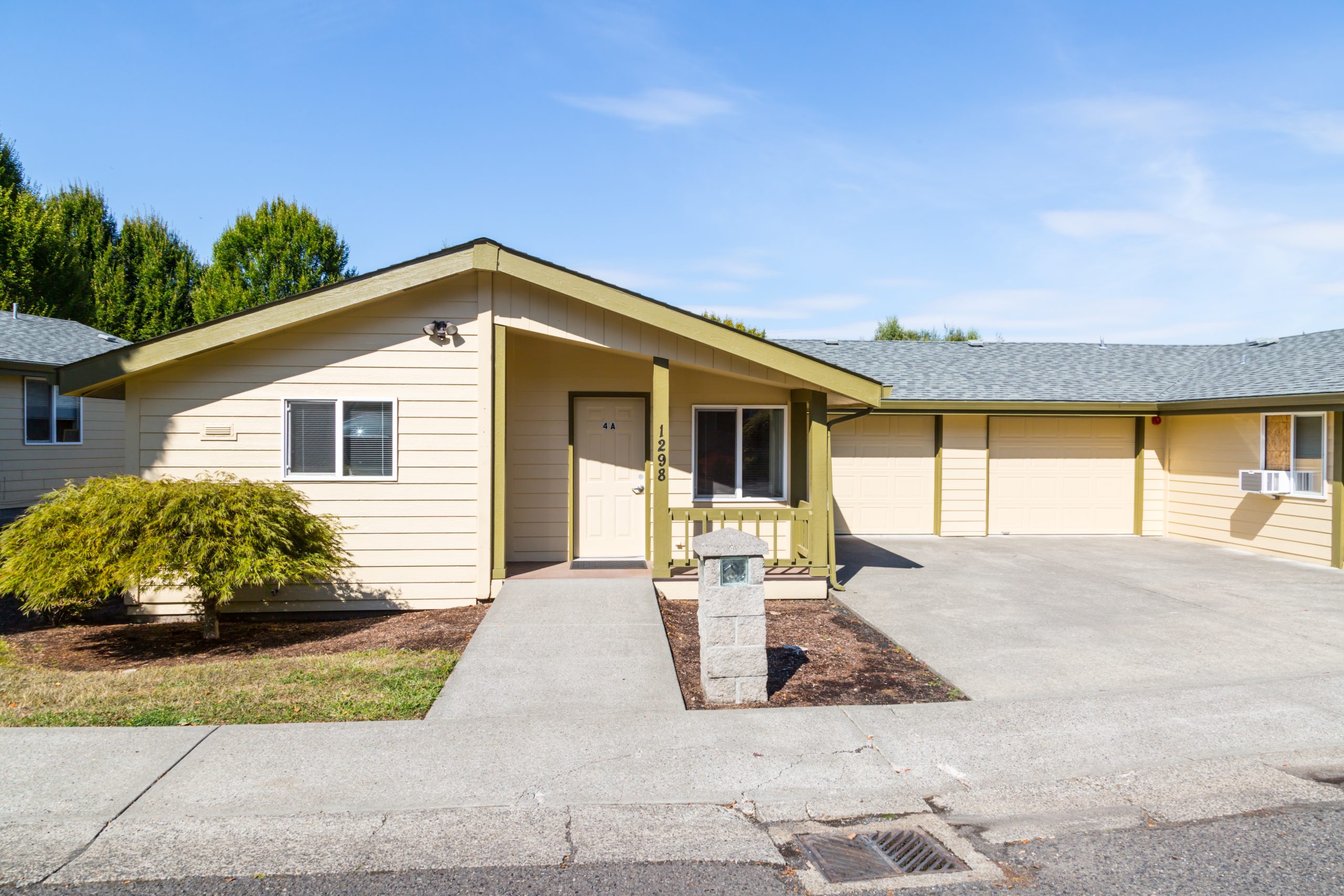 The exterior of a yellow single-story residential rehab facility.