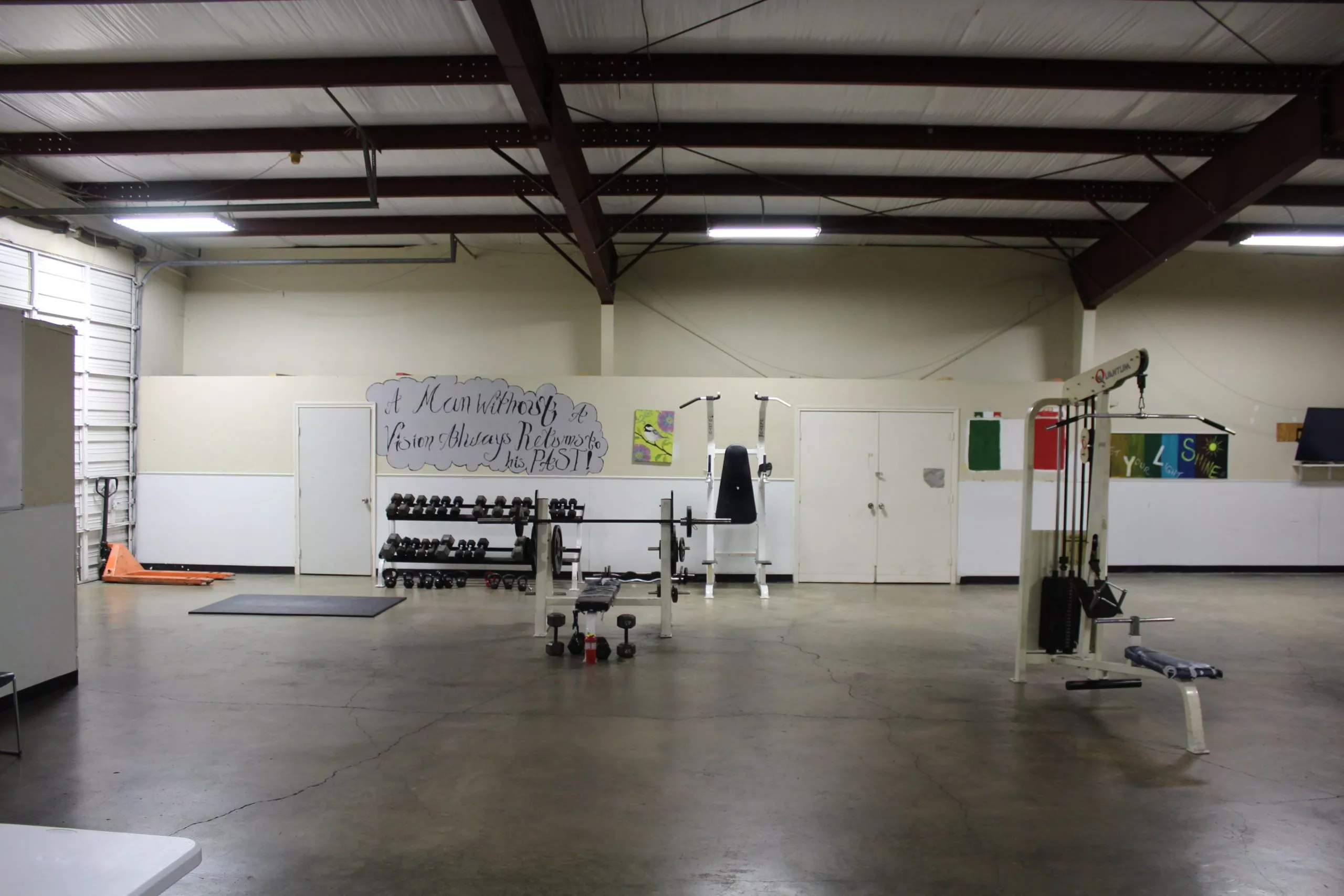 Spacious indoor gym with weight racks and resistance machines