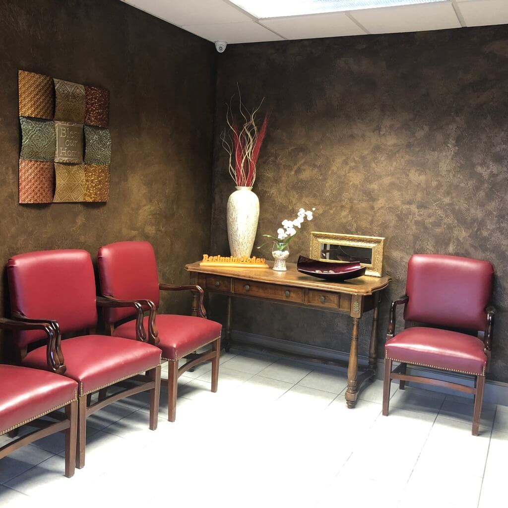 Lounge with red chairs and dark wall decor