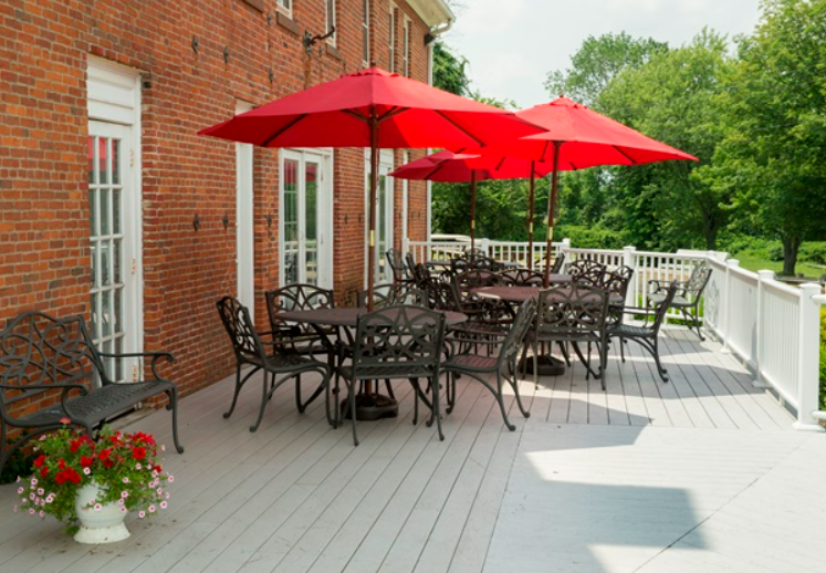 Patio with tables, chairs, and red umbrellas
