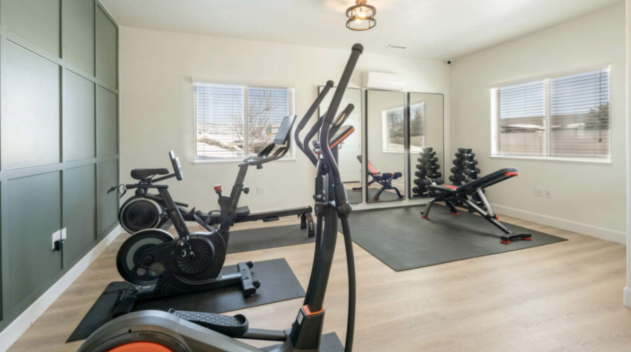 Women’s residential rehab fitness room with cardio and weights