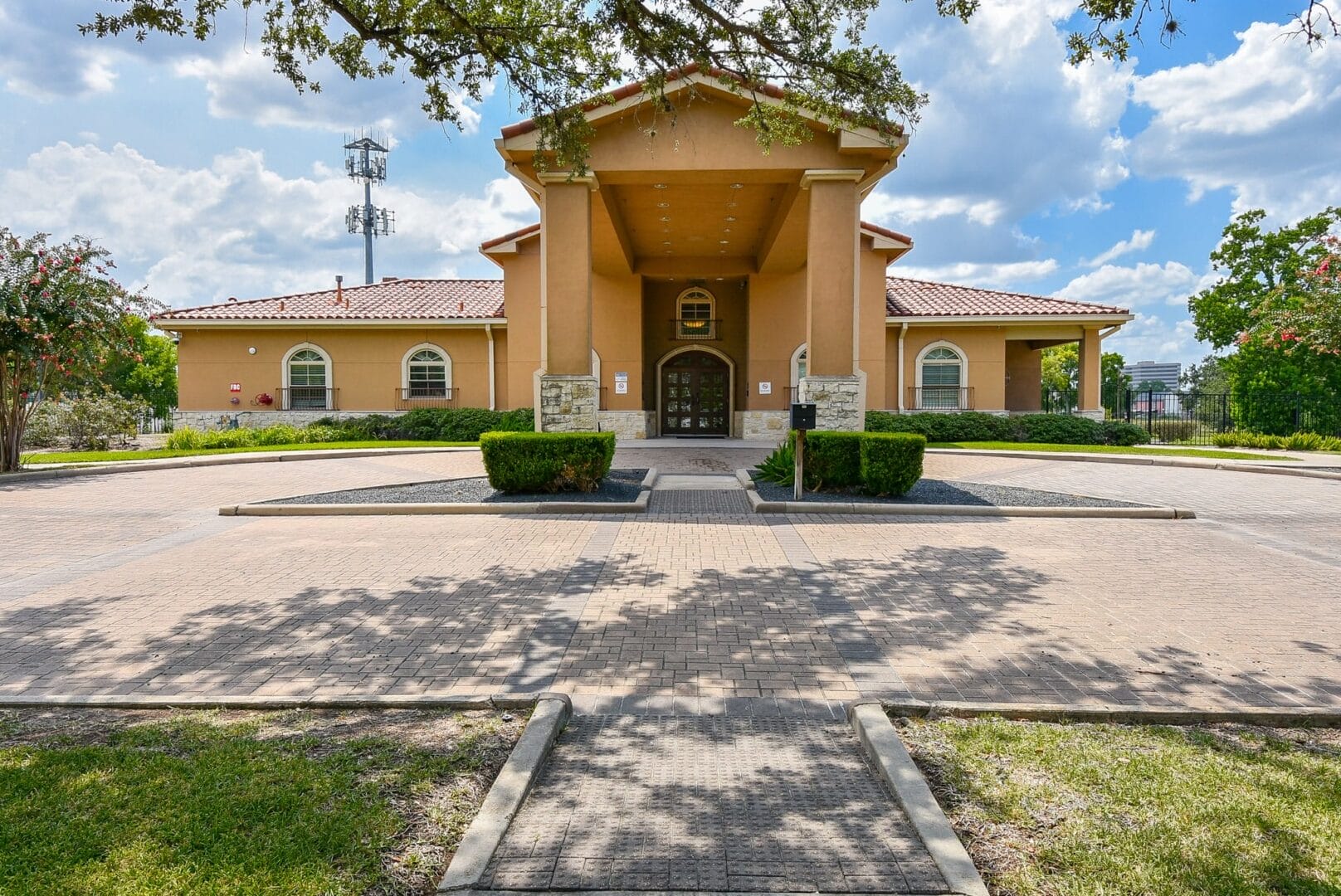Rehab facility entrance with red-tiled roof and greenery.