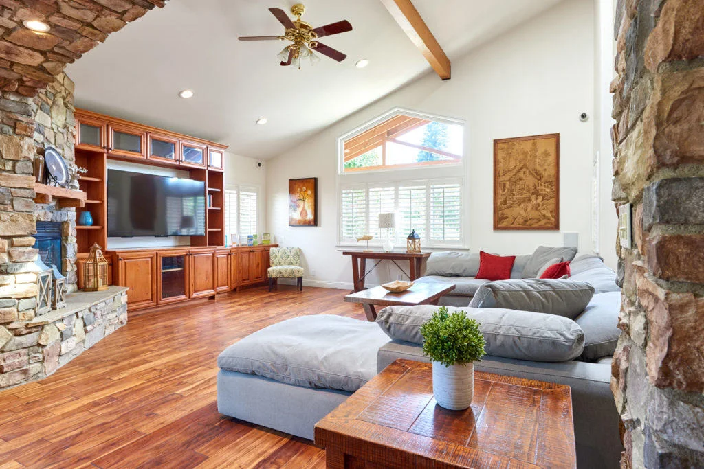 Cozy living room with stone fireplace and large sectional sofa