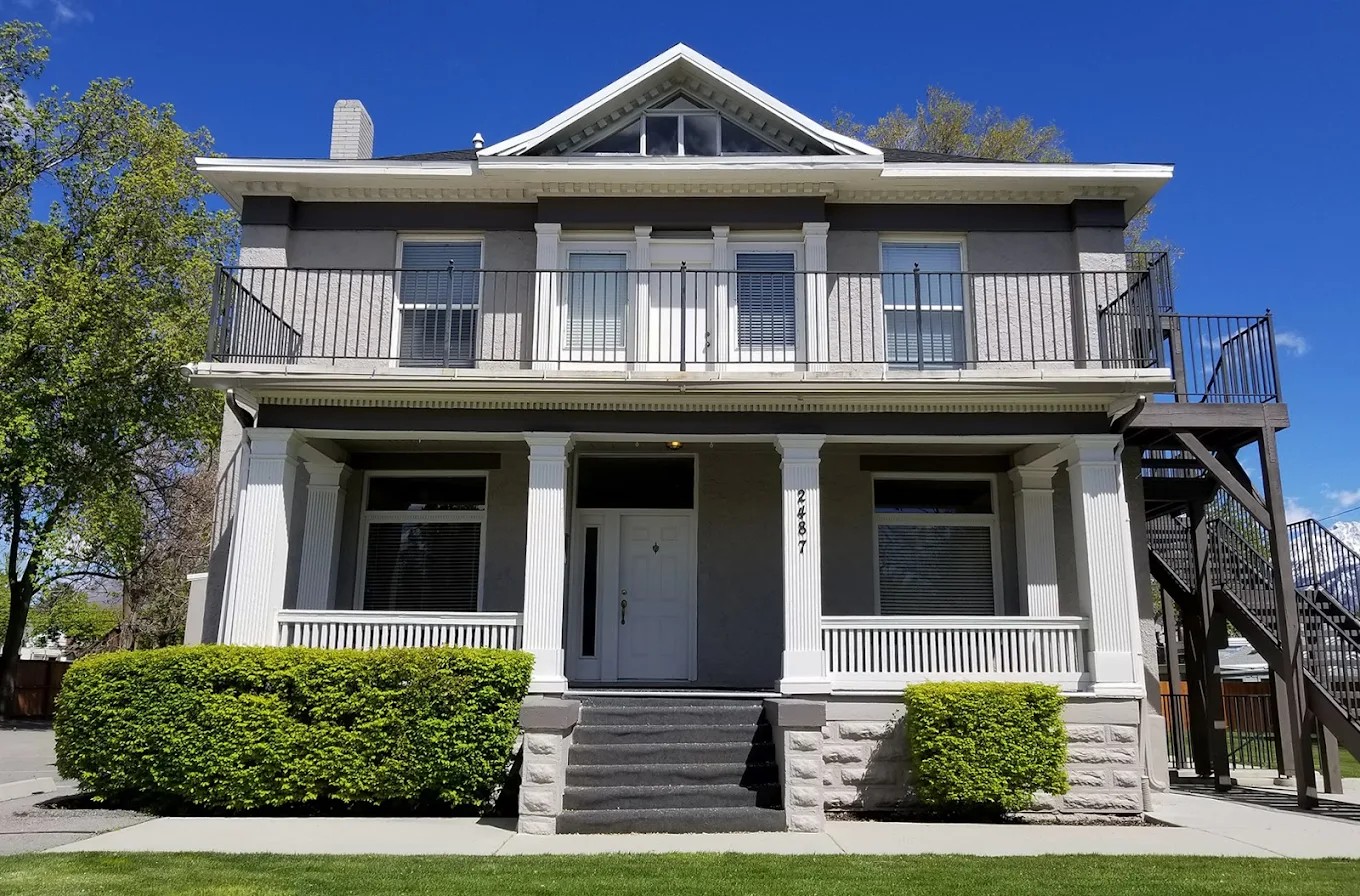 Front view of two-story rehab facility with porch and columns
