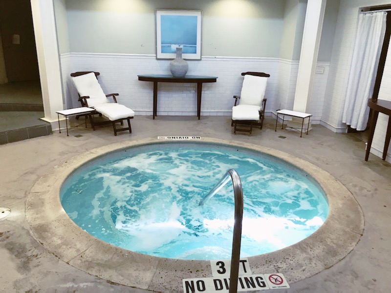 A small indoor spa with lounge chairs.