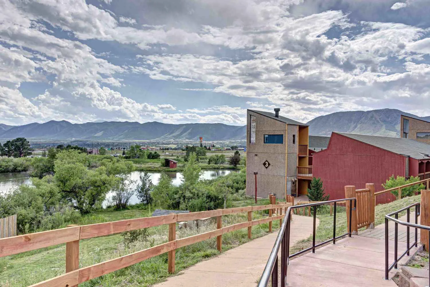 Walkway to facility with lake in vew.