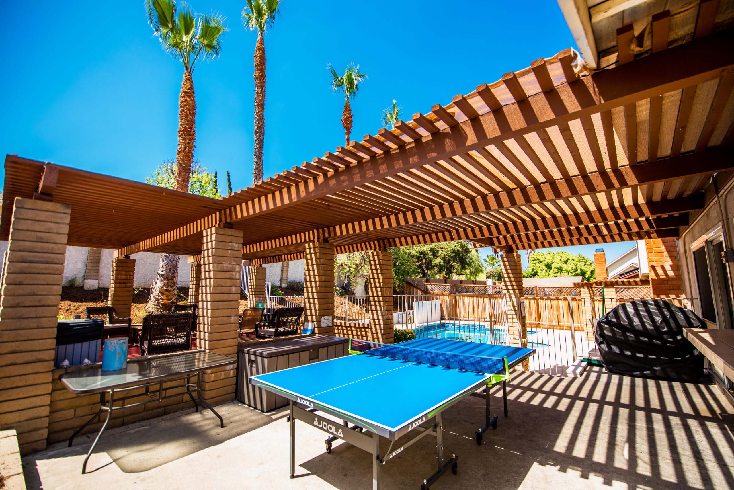 Covered patio with ping pong table and seating