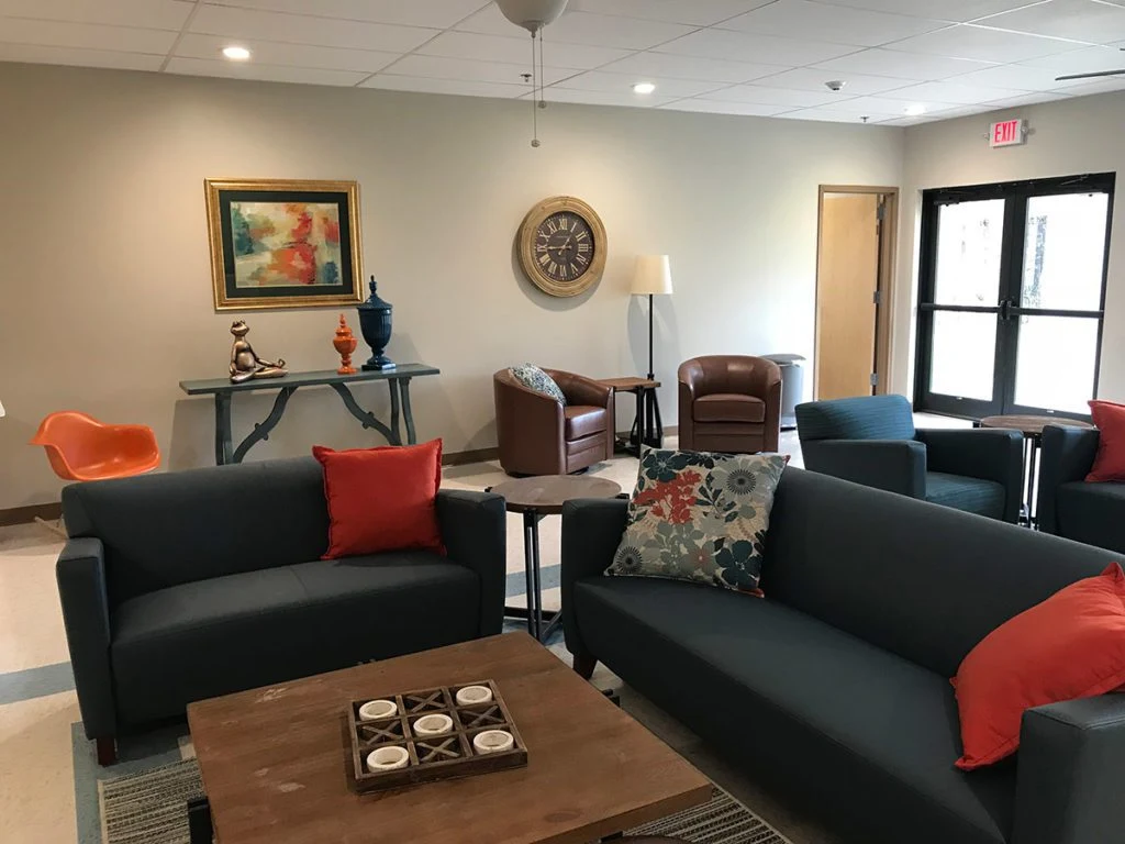 Living room with sofas, coffee table, and art decor