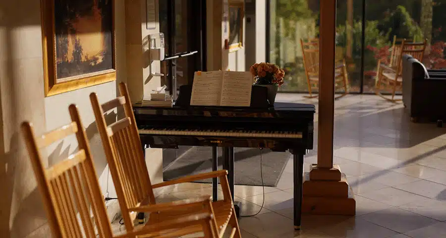 Piano area with seating and natural light from windows