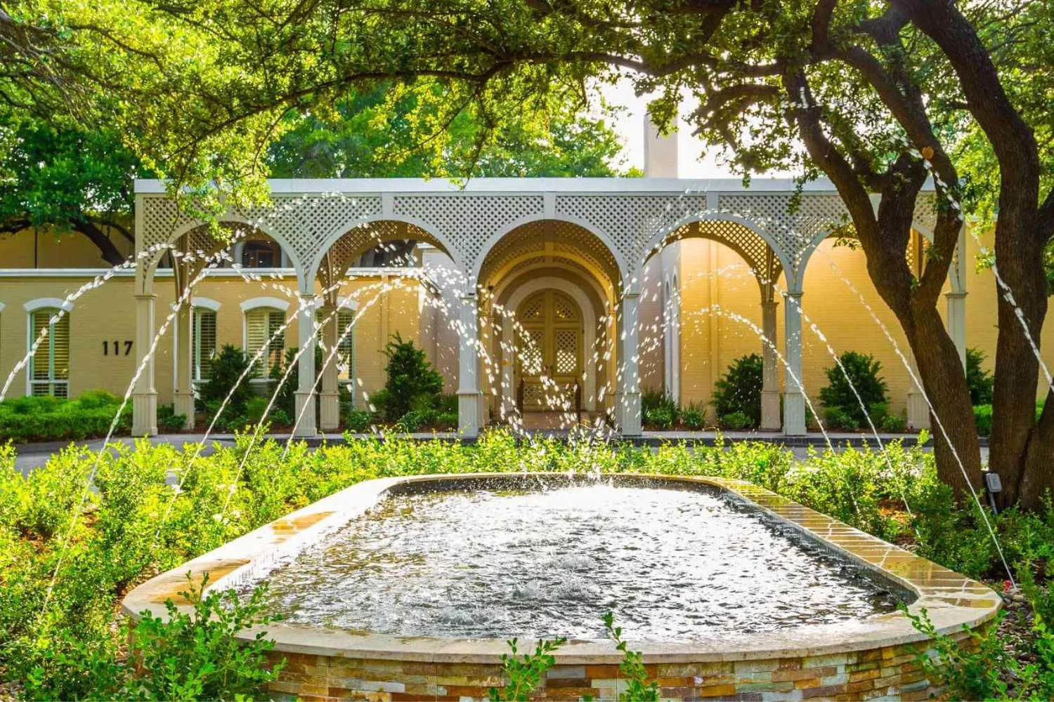 A courtyard fountain with arched entry at a rehab facility.