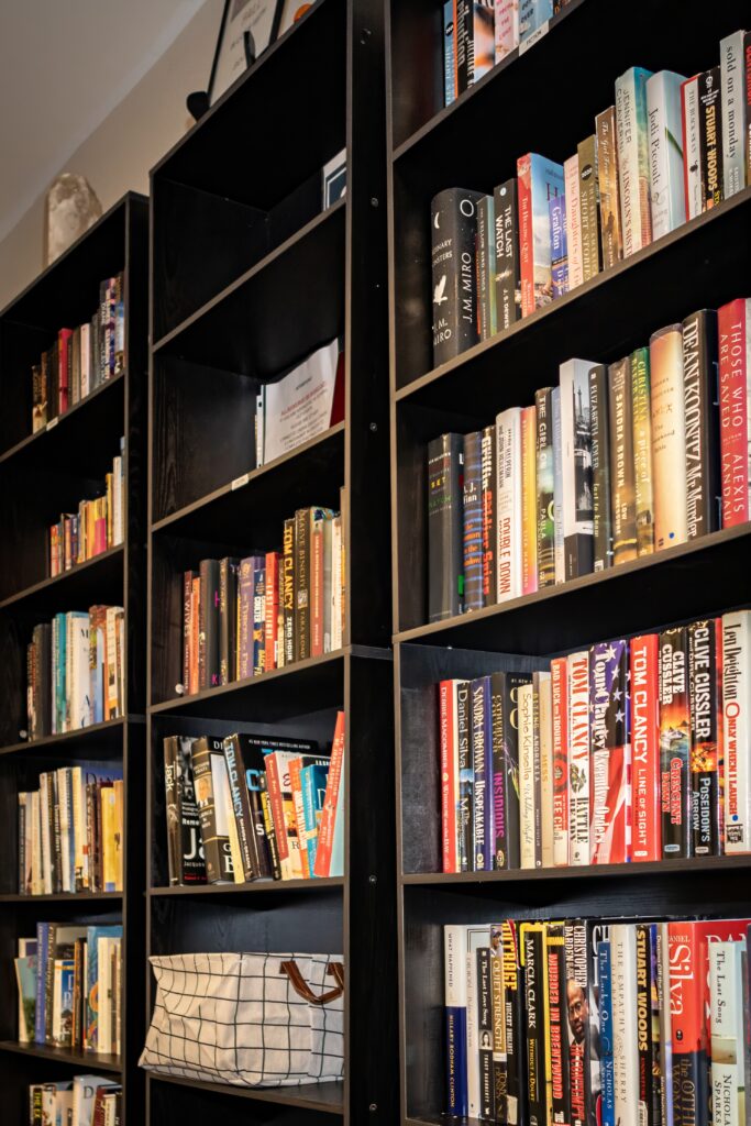 Tall black bookshelves filled with colorful titles