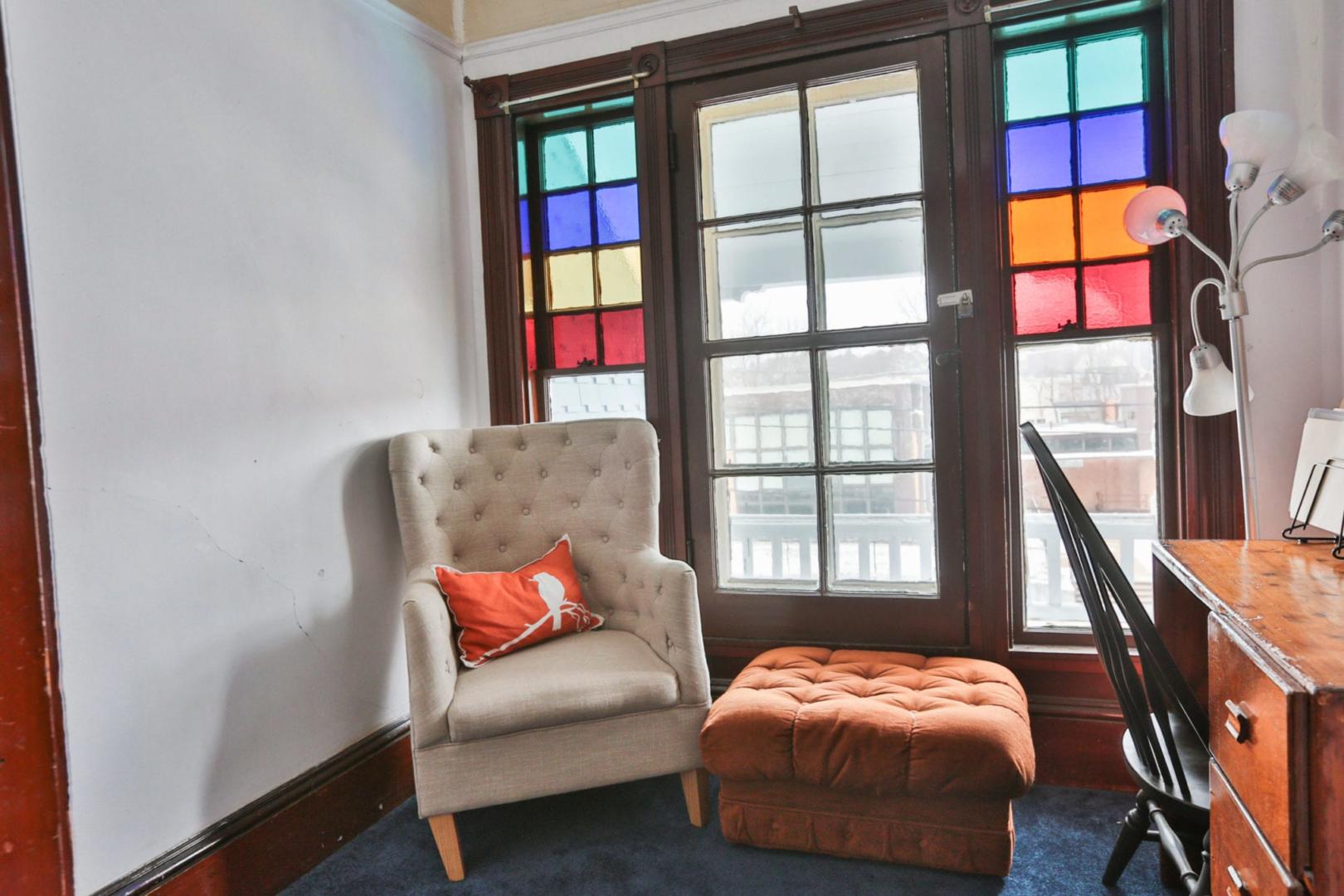 Armchair and ottoman by stained glass windows