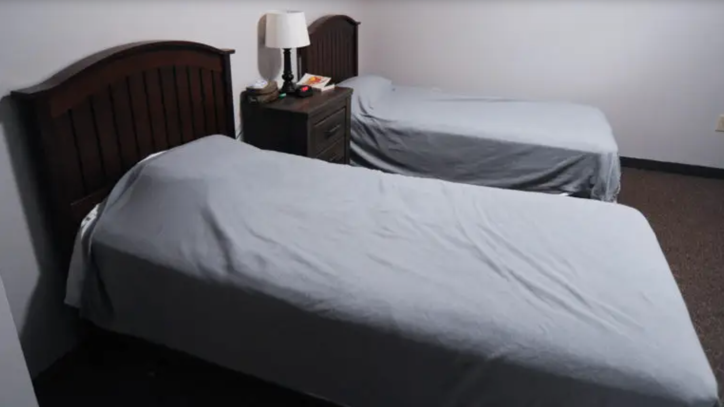 Shared bedroom with two twin beds in a recovery residence.