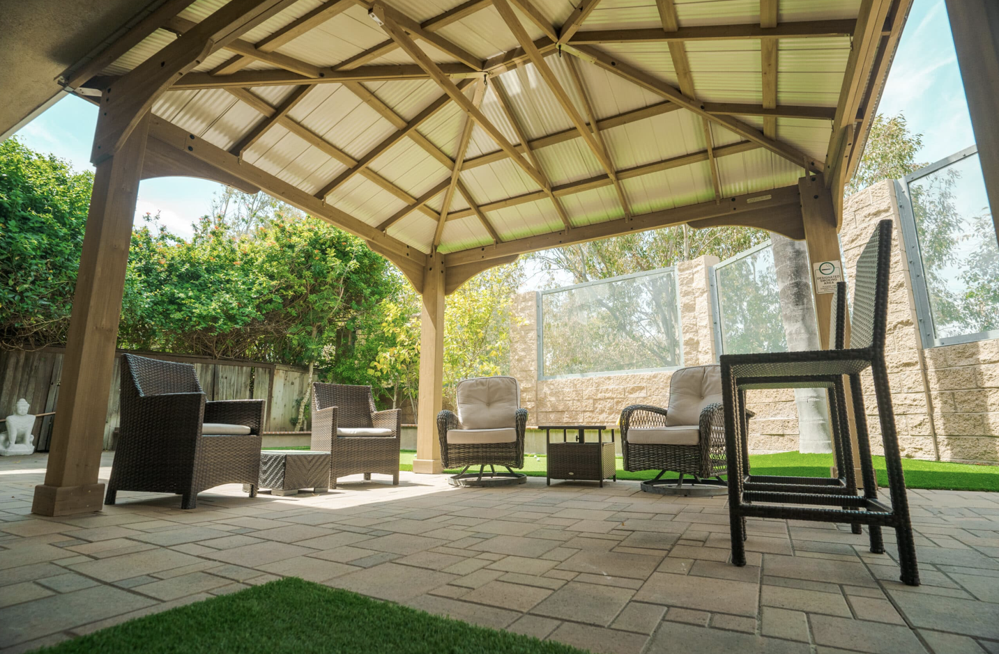 Shaded Outdoor common area with chairs arranged in a circle.