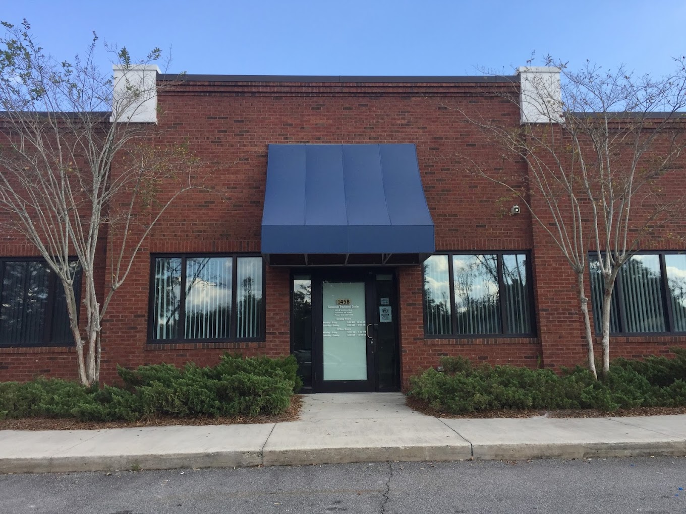 Facility entrance with awning and signage.