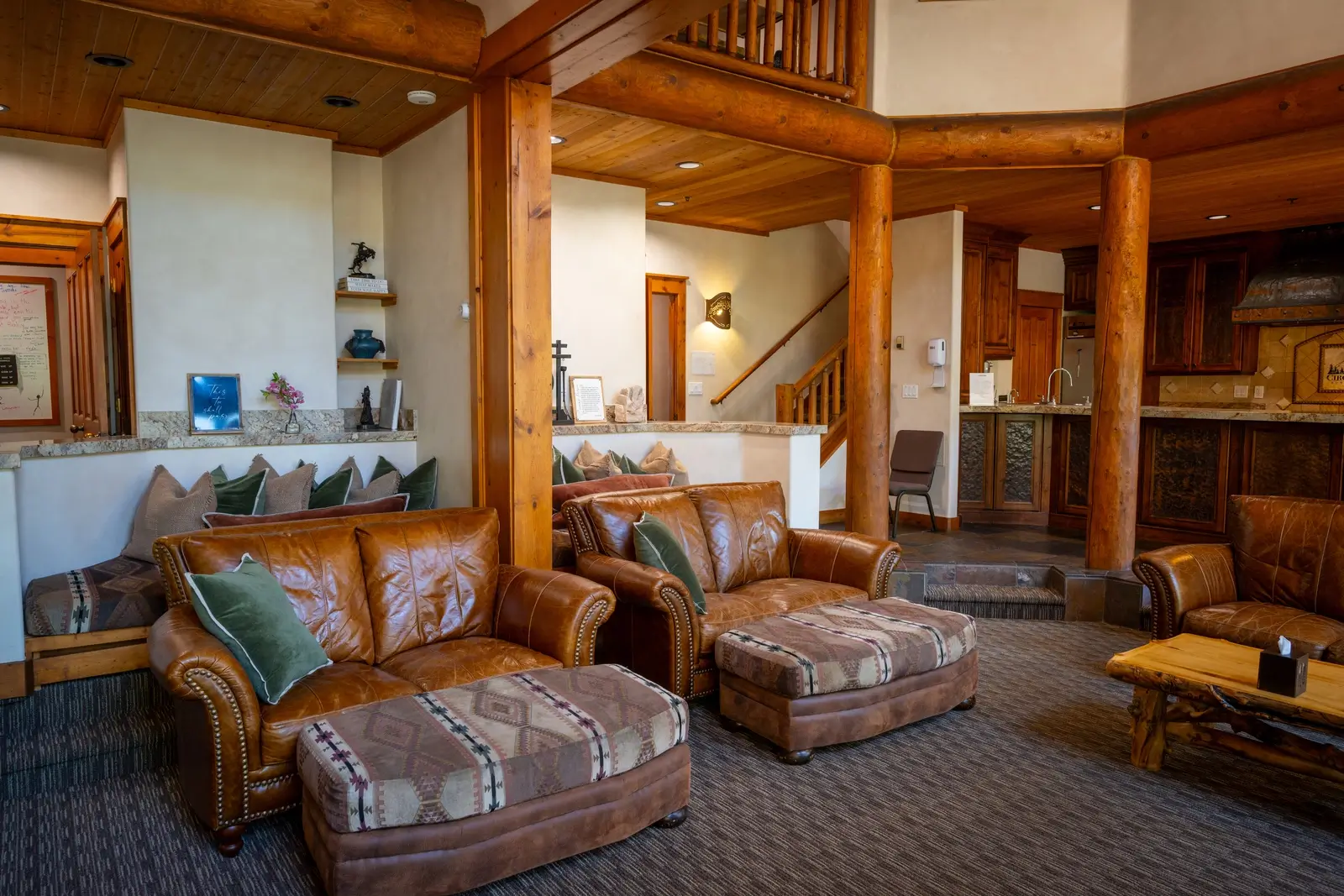 Leather seating area with exposed beams and rustic charm