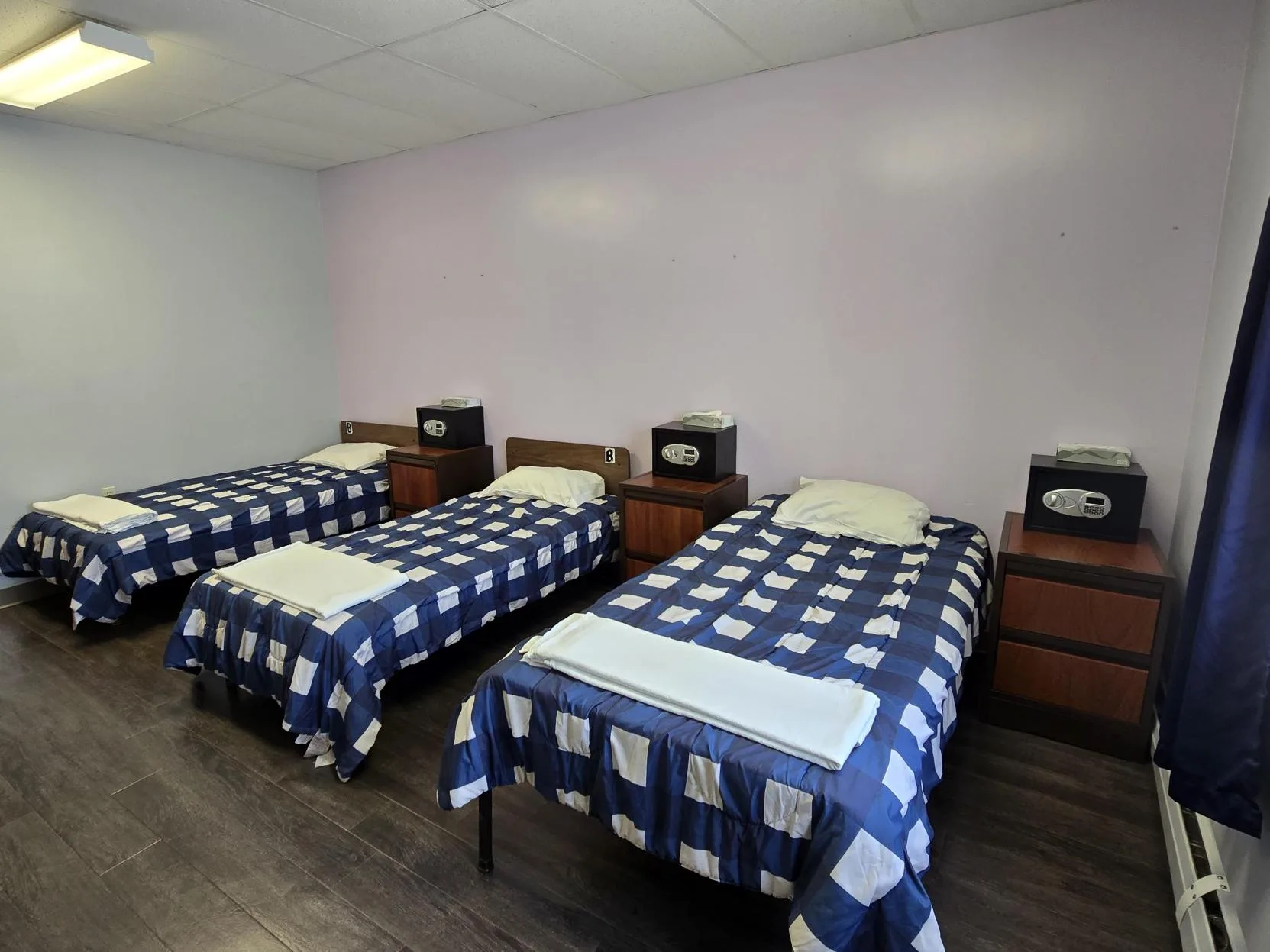 Three twin beds with blue and white bedding