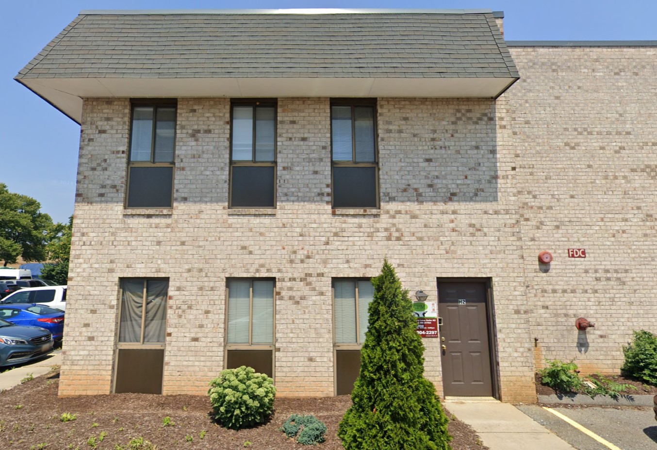 Cozy entrance to Frederick Institute, featuring a clean brick exterior and neatly landscaped surroundings.