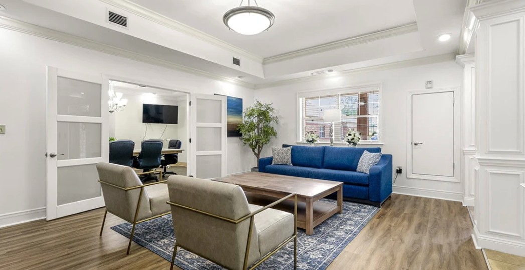 Comfortable lounge area adjacent to a conference room for family meetings and consultations