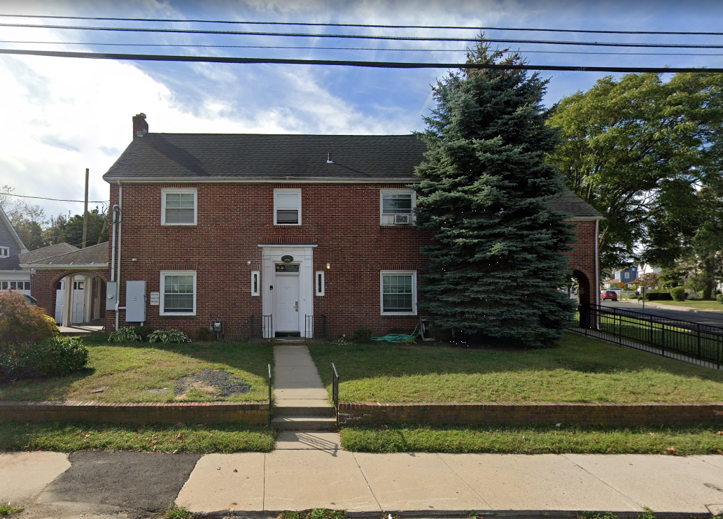 Brick exterior of Philip House with front walkway and lawn